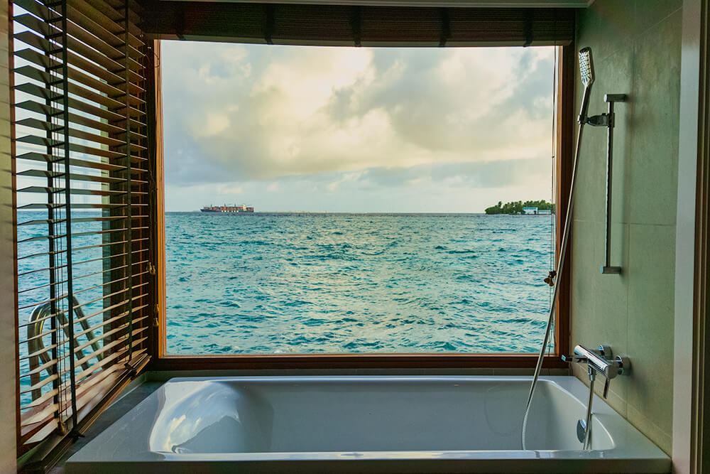 overwater bungalow bathroom at the sheraton maldives full moon resort & spa